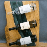 Epoxy River Wine Rack with wine bottles on hooks